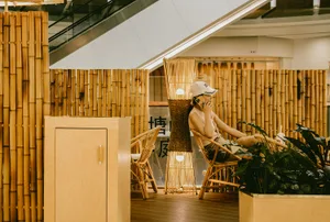 A relaxed indoor space with chairs, tables, and people socializing in a restaurant or cafe setting
