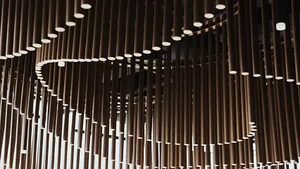 A room with a circular arrangement of wooden beams and columns creating a warm and natural atmosphere