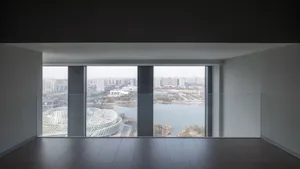 Aerial view of a city skyline with modern buildings constructed from concrete and glass, bathed in natural light
