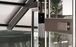 A bright and inviting space with large windows, a doorway, and plants, filled with natural light and a sense of openness