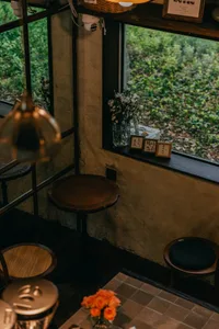 Dining area with a wooden table and wicker chairs, creating a cozy atmosphere for gatherings and meals