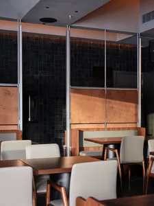 Warm and inviting restaurant interior with wooden tables and chairs, well-designed lighting, and a rustic atmosphere