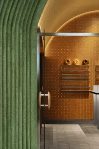 Cozy home office with a green carpet, a shelf with two donuts, and a welcoming atmosphere