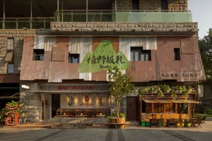 A restaurant with a dining area, tables, chairs, and potted plants, creating an inviting and comfortable atmosphere