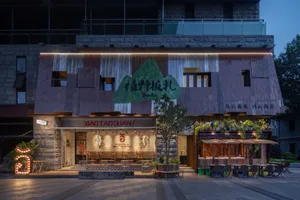 Cozy Asian restaurant with a large dining area, potted plants, and inviting atmosphere