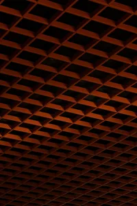 A warm and inviting interior space with an orange brick wall featuring a geometric pattern of squares