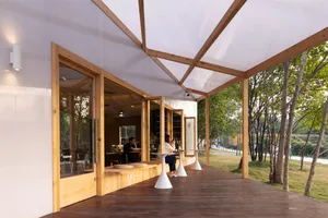 Inviting restaurant dining space with wooden tables, chairs, and people enjoying meals in a relaxed atmosphere