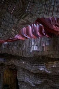 A geometric pattern made from stacked and arranged books, creating a visually appealing and thought-provoking art installation