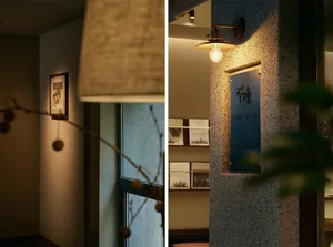 Comfortable hotel lobby with lamps, books, and a potted plant, creating a warm and inviting atmosphere