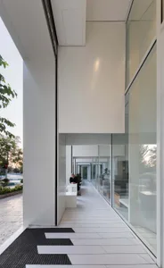 A modern lobby with natural light, potted plants, and comfortable seating for visitors