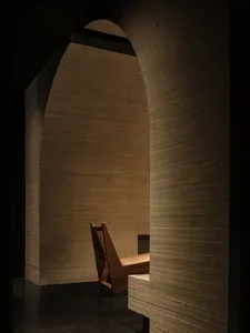 Dimly lit dining room with a wooden chair and dining table, creating a cozy atmosphere