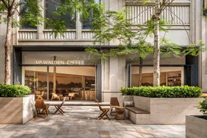 A patio seating area with chairs and tables, umbrellas, and a welcoming atmosphere