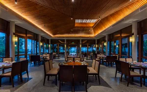 Empty restaurant with wooden floors and tables, chairs, and a calm inviting atmosphere