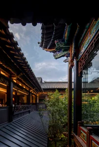 Exterior photo of an Asian-style building with a large roof, multiple windows, and a blend of wood and metal elements