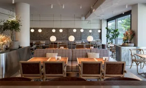 Warm and inviting restaurant interior with wooden tables and chairs, soft ambient lighting, and a cozy atmosphere