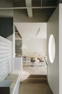Empty restaurant with a large dining area featuring multiple tables and chairs, benches, and a clean, well-organized atmosphere