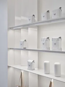 A well-organized shelf in a store filled with various bags of coffee, creating a cozy and inviting atmosphere for customers