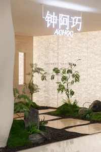 A serene indoor space with a large white wall featuring potted plants of varying heights, creating a lush atmosphere with two vases placed on either side of the wall
