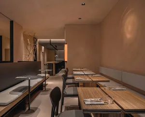 Modern restaurant interior with wooden tables and chairs, creating a warm and inviting atmosphere