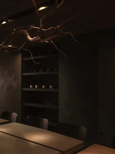 Dining area with a wooden table surrounded by chairs, creating a cozy and inviting atmosphere for gatherings and meals