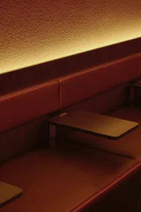 Warm and inviting cafe interior with wooden benches, brown wood accents, and a cozy atmosphere