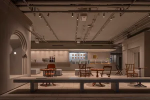 Open modern living space with a dining table, chairs, kitchen area, and a couch, featuring a functional and comfortable design