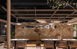 A modern dining area with multiple tables and chairs in various styles, set against a neutral background