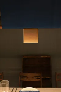 A cozy room with two chairs in front of a wooden bookshelf, creating a warm and inviting seating area