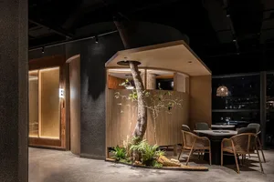 A modern dining space with a wooden table and chairs, surrounded by wood paneling walls, creating a warm and inviting atmosphere