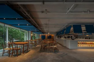 燈光柔和的餐廳，設有餐桌與椅，設計融合木質與金屬元素