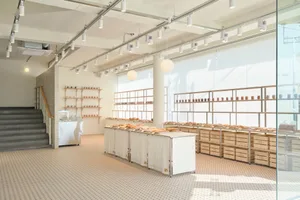 Clean and organized kitchen area with a large countertop featuring various items, bottles, and bowls, with a focus on food preparation and presentation