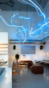 A spacious dining area with multiple tables and chairs, potted plants, and an inviting atmosphere