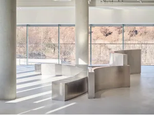 Open space with large windows, benches, and natural light