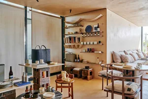 A well-organized showroom with bottles, bowls, and vases on display, creating a stylish and inviting atmosphere