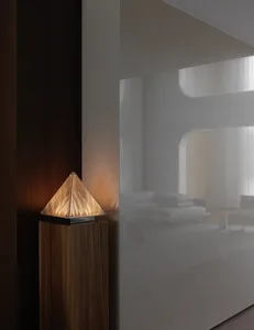 A modern living room with a couch, two chairs, a lamp, and a small table, creating a well-lit and inviting atmosphere