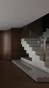 A traditional staircase with wooden steps, leading to another level in a building, with natural light and a sense of simplicity and elegance