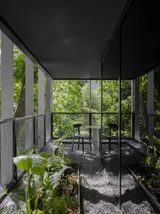 A well-lit dining room with a wooden dining table and chairs, surrounded by inviting decor and natural light