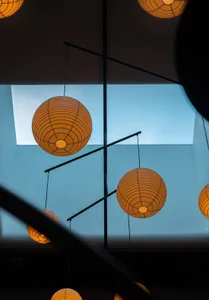 A warm and inviting interior space with five paper lantern-style ceiling lights providing soft illumination
