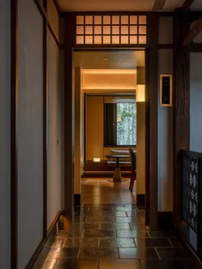 Warm and inviting interior hallway with wooden floors and walls, featuring a dining table, chairs, and natural light