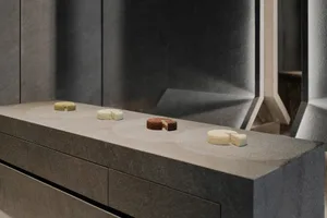 A kitchen countertop made of marble displays four types of cakes in an organized manner, creating a cozy and inviting atmosphere