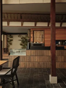Cozy cafe interior with a wooden counter, chairs, and decorative items