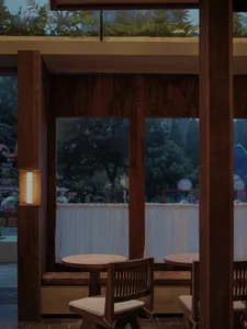 Warm and inviting dining area with a large window, wooden furniture, and a dining table in the center of the room