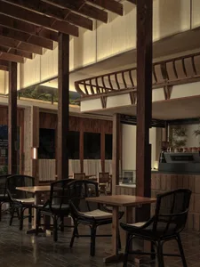 Warm and inviting restaurant interior with wooden walls and ceilings, multiple dining tables, chairs, and potted plants