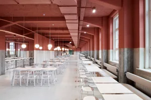 Modern dining area with white tables and chairs, well-lit and inviting
