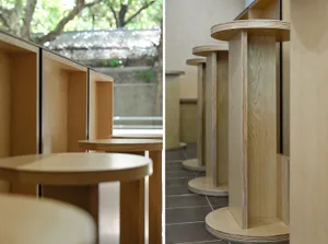 A restaurant interior with wooden tables, chairs, and benches, creating a cozy and inviting atmosphere with a focus on functionality and aesthetics