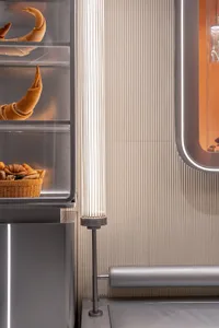 A kitchen with a refrigerator containing bowls, bananas, and a cup, showcasing a functional and organized space