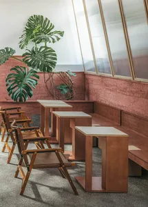 Warm and inviting restaurant interior with wooden tables and chairs, brown in color