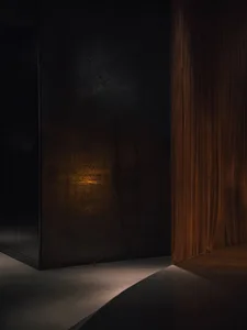 A black doorway with an orange curtain in front of it, set against a stone wall, creating a warm and inviting atmosphere