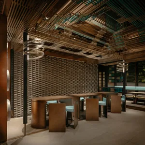 Warm and inviting restaurant interior with wooden tables and chairs, creating a cozy atmosphere for guests