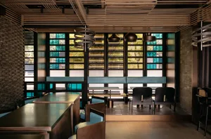 A modern restaurant interior with several tables and chairs, inviting atmosphere, and comfortable seating for guests